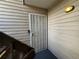 Apartment entrance with security door and wooden steps at 3613 S Sheridan Blvd # 16, Denver, CO 80235