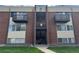 Brick apartment building featuring two balconies and an open staircase entrance at 3613 S Sheridan Blvd # 16, Denver, CO 80235