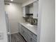Modern kitchen with grey cabinets, mosaic backsplash, and stainless steel faucet at 3613 S Sheridan Blvd # 16, Denver, CO 80235