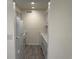 Galley-style kitchen with white appliances, cabinets, and wood-look floors at 3613 S Sheridan Blvd # 16, Denver, CO 80235