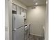 Kitchen featuring white appliances and cabinetry with wood-look floors at 3613 S Sheridan Blvd # 16, Denver, CO 80235