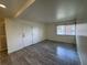 Bright living room features wood-look floors, a window, and white walls at 3613 S Sheridan Blvd # 16, Denver, CO 80235