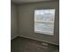 Bedroom with a large window offers natural light and street views at 5151 Jasper St, Denver, CO 80239