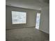 Living room with carpet, large window and glass door at 5151 Jasper St, Denver, CO 80239