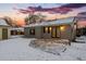 Updated home with a backyard patio and snowy landscape at 3341 W Belmont Ave, Littleton, CO 80123