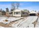 Charming ranch home with snowy landscaping and a brick pathway at 3341 W Belmont Ave, Littleton, CO 80123