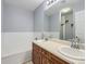 Bathroom featuring double sinks, wooden cabinets and large mirror at 6426 Silver Mesa Dr # C, Highlands Ranch, CO 80130