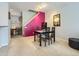 Well-lit dining area featuring a modern table set and a colorful accent wall at 6426 Silver Mesa Dr # C, Highlands Ranch, CO 80130