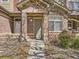 Welcoming entrance with brickwork, a front door, and a small landscaped area at 6426 Silver Mesa Dr # C, Highlands Ranch, CO 80130