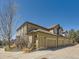 Multi-level home featuring a three car garage, side yard, and beige colored siding at 6426 Silver Mesa Dr # C, Highlands Ranch, CO 80130