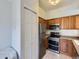 Modern kitchen features stainless steel appliances and wood cabinets at 6426 Silver Mesa Dr # C, Highlands Ranch, CO 80130