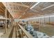 Interior view of barn, wooden ceiling beams, metal walls and packed dirt floor at 402 S County Road 129, Bennett, CO 80102