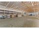 Wide shot of the inside of the barn featuring a packed dirt floor and wood beam ceiling at 402 S County Road 129, Bennett, CO 80102