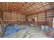 Large barn interior with hay storage and tractor at 402 S County Road 129, Bennett, CO 80102