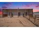 Three-stall barn with covered stalls and adjacent fenced area at 402 S County Road 129, Bennett, CO 80102