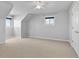 Bright bedroom features neutral walls and carpeting, large windows, and a ceiling fan at 402 S County Road 129, Bennett, CO 80102