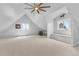 Bright bonus room with vaulted ceiling, fan, bench seating and a picturesque view from the window at 402 S County Road 129, Bennett, CO 80102