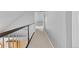 Upstairs hallway with neutral wall color, plush carpeting, and a white wood railing with black accents at 402 S County Road 129, Bennett, CO 80102