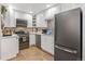 Modern kitchen with stainless steel appliances and white cabinetry at 402 S County Road 129, Bennett, CO 80102