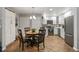 Modern kitchen with white cabinets, stainless steel appliances and breakfast nook at 402 S County Road 129, Bennett, CO 80102