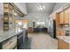 Bright kitchen with granite countertops, wooden cabinets, and a large island at 402 S County Road 129, Bennett, CO 80102