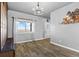 Bright and airy formal living room with hardwood floors, natural light, and neutral wall color at 402 S County Road 129, Bennett, CO 80102