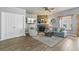 Cozy living room features hardwood flooring, a stone fireplace, neutral wall colors, and comfortable seating at 402 S County Road 129, Bennett, CO 80102