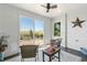 Bright sunroom with sliding glass doors leading to a backyard patio at 402 S County Road 129, Bennett, CO 80102