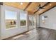 Sunroom with wood ceilings, sliding glass doors, and scenic views at 402 S County Road 129, Bennett, CO 80102