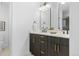 Double vanity bathroom with dark brown cabinets and gold accents at 1256 Newton St # 1, Denver, CO 80204