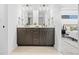 Double vanity bathroom with dark brown cabinets and gold accents at 1256 Newton St # 1, Denver, CO 80204