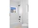 Clean bathroom with a shower/tub combo and updated fixtures at 1256 Newton St # 1, Denver, CO 80204