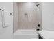 Clean bathroom with a shower/tub combo and tile surround at 1256 Newton St # 1, Denver, CO 80204