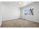 Well-lit bedroom featuring neutral carpeting and large windows at 1256 Newton St # 1, Denver, CO 80204