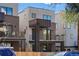 Modern three-story townhome with dark brick exterior and balcony at 1256 Newton St # 1, Denver, CO 80204