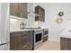 Contemporary kitchen with dark wood cabinets and quartz counters at 1256 Newton St # 1, Denver, CO 80204