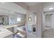 Bright bathroom featuring a soaking tub and separate vanities with plenty of counter space at 8917 E Chenango Ave, Greenwood Village, CO 80111