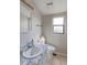 Cozy bathroom with window lighting, a toilet, sink, and mirror at 8917 E Chenango Ave, Greenwood Village, CO 80111