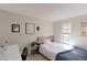 Carpeted bedroom with a twin bed, an exposed frame headboard, and a small desk at 8917 E Chenango Ave, Greenwood Village, CO 80111