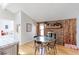 Dining area showcasing a fireplace with a wood-paneled wall and a glass-top table with chairs at 8917 E Chenango Ave, Greenwood Village, CO 80111