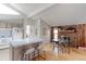 Open kitchen area featuring a central island, stainless steel appliances, and an adjacent dining space at 8917 E Chenango Ave, Greenwood Village, CO 80111