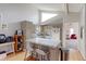 Bright kitchen with white appliances, an island with seating, and hardwood floors at 8917 E Chenango Ave, Greenwood Village, CO 80111