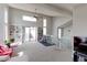 Spacious living room featuring large windows, built-in shelving, and access to an outdoor deck at 8917 E Chenango Ave, Greenwood Village, CO 80111