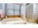 Spa-like bathroom with soaking tub, glass block shower, and updated fixtures at 14994 Fillmore Way, Thornton, CO 80602