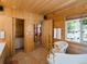 Relaxing bathroom features a standalone tub, wood walls and tile flooring at 451 Harris Dr, Idaho Springs, CO 80452