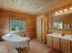 Bright bathroom features a classic standalone tub and natural wood finishes throughout at 451 Harris Dr, Idaho Springs, CO 80452