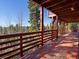 Exterior of a wood deck overlooking a forest filled with green trees in the distance at 451 Harris Dr, Idaho Springs, CO 80452