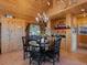 Charming dining room features natural wood, a classic chandelier, and a view of the outdoors at 451 Harris Dr, Idaho Springs, CO 80452