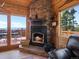 Living room featuring stone fireplace and access to deck at 451 Harris Dr, Idaho Springs, CO 80452