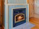 Charming fireplace with wood trim and stone hearth, perfect for cozy evenings at 451 Harris Dr, Idaho Springs, CO 80452